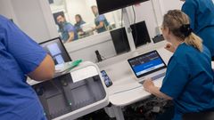 Photograph shows doctors operating the remote thrombectomy machine (Image: Emma Alexander)/Thenational.scot