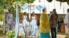 Natasha, Karugire and their children before President Museveni and the First Lady