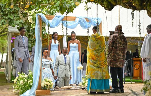 Natasha, Karugire and their children before President Museveni and the First Lady