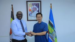 PS  Vincent Bagiire Waiswa poses for a hand shake photo with Ambassador Zhang Lizhong the Ambassador of China to Uganda