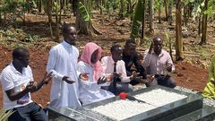 Alex Luswa Luwemba praying at the grave of Muhammad Ssegirimya