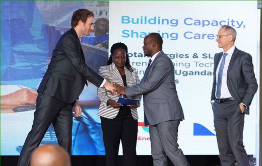 Valerian PFRIMMER, Managing Director for East and South Africa at SLB hands over the programme implementation agreement to Prof. Jude T. Lubega the Vice Chancellor of Nkumba University