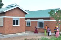 Hon Alice Kaboyo handing over the new home to the family of  the late Yoram Kisuze in Namusaale, Kapeeka, Nakaseke District.