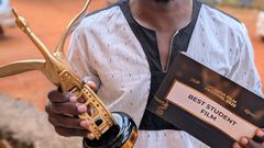 Douglas Byaruhanga (L) recieving an accolade from MultiChoice Uganda Managing Director, Hassan Saleh.