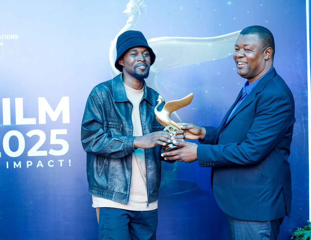 Brian Kabogozza with the accolade he won during the just concluded Uganda Film Festival awards.