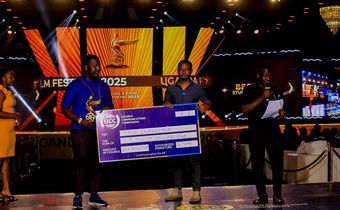 Emma Illungole (L) and Kefa Senoga (R) recieving the Award on behalf of Brian Kabogozza and Douglas Byaruhanga