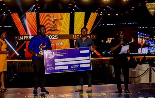 Emma Illungole (L) and Kefa Senoga (R) recieving the Award on behalf of Brian Kabogozza and Douglas Byaruhanga