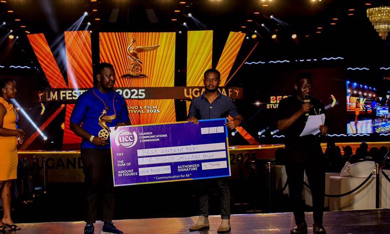 Emma Illungole (L) and Kefa Senoga (R) recieving the Award on behalf of Brian Kabogozza and Douglas Byaruhanga