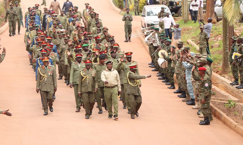 Retirees leaving the MoDVA HQ in Mbuya, waving as a symbol of their departure from active service.