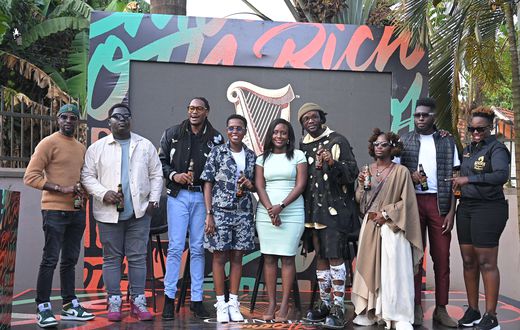 The influencers pose for a photo with Elizabeth Mutamuliza, Head of Beer at Uganda Breweries Limited (middle)