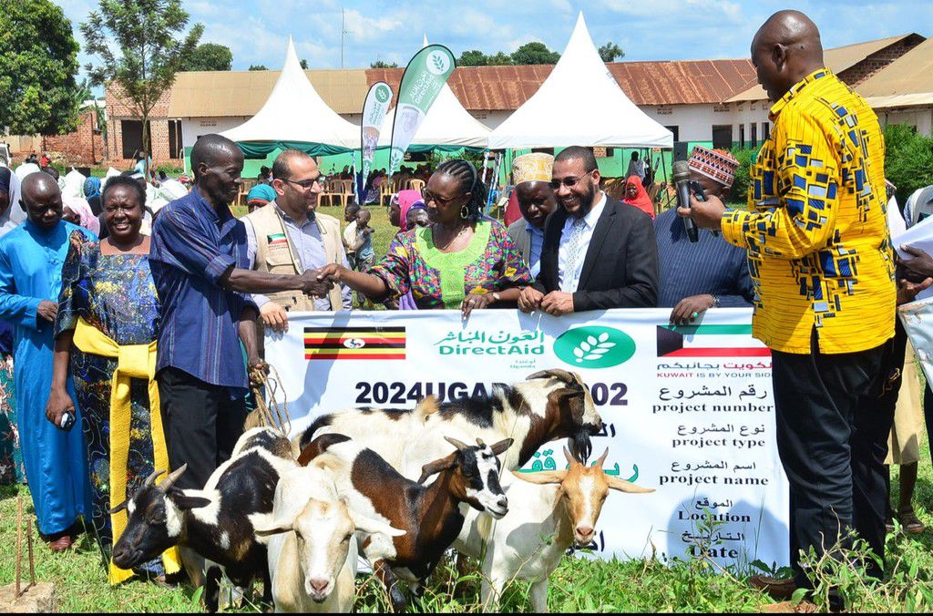 Minister Alice Kaboyo handing over the goats to the beneficiary families
