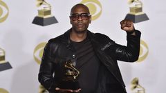Dave Chappelle holding a Grammy Award