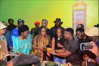 (R-L) The Uganda Breweries Marketing Director Catherine Ndungu hands over a bottle of Uganda Waragi to Hon Rebecca Kadaga at the Nyege nyege festival inn Jinja