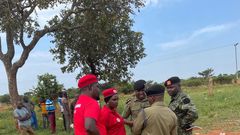 NUP supporters (in red) conferring with Uganda Police.