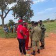 NUP supporters (in red) conferring with Uganda Police.