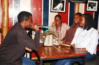 Diego The Dark Knight Poet, serenading the audience at Stand-up and Slam, Arena Bar and Grill, Kampala, 2019.
