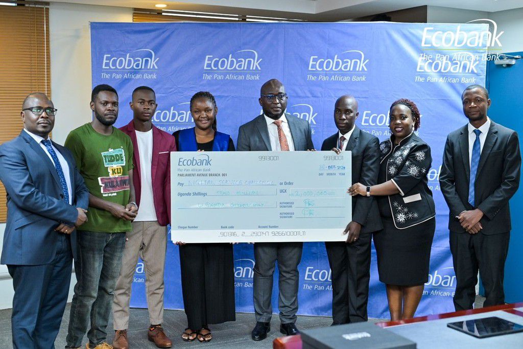 Ecobank Uganda’s Managing Director, Grace Muliisa hands a cheque to one of the winning enterprises