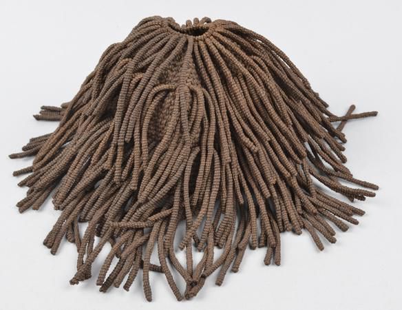 String crocheted cap with twisted string tassels: