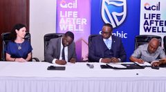 Stanbic Bank's Head Of Investment Banking - Paula Coetzee, Executive Director Paul Muganwa, Chief Executive Mumba Kalifungwa together with Businessman Emmanuel Katongole during the partnership signing (1)