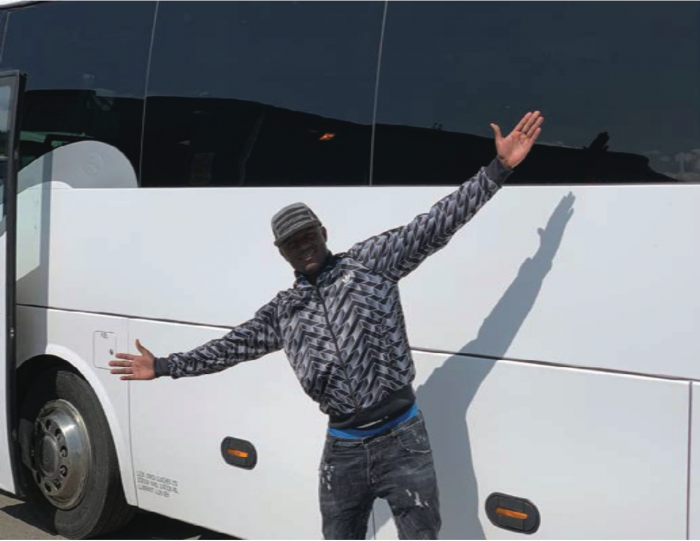 Victor Wanyama poses for a photo with the bus he bought for Country Bus FC and Muthurwa Boxing Club