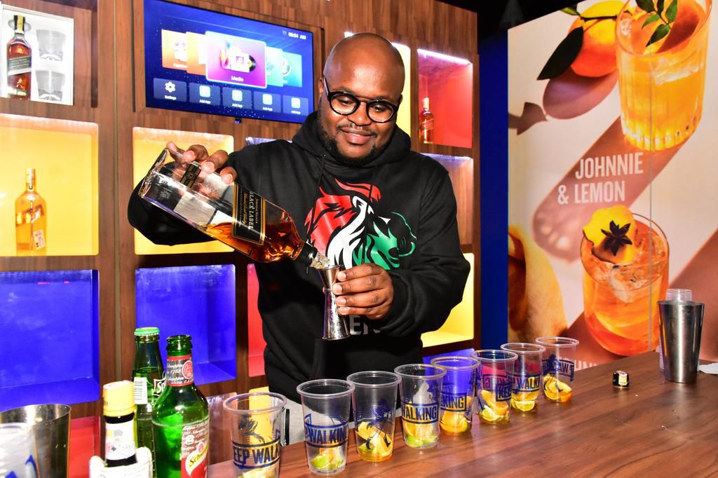 JOE MUCHIRI MAKES A JOHNNIE WALKER HIGHBALL BEHIND THE BAR