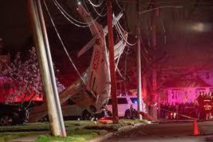 A crashing small plane was snagged by power lines, stopping a foot from disaster