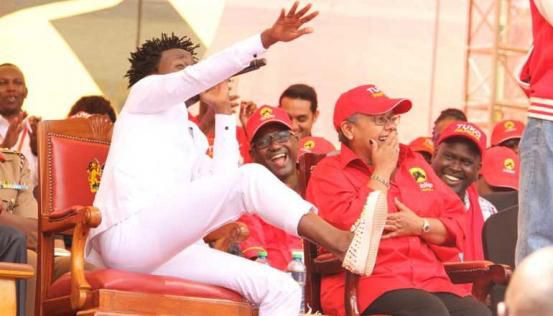 Bahati sitting on President Uhuru's chair during the launch of Jubilee Party at Kasarani in 2016