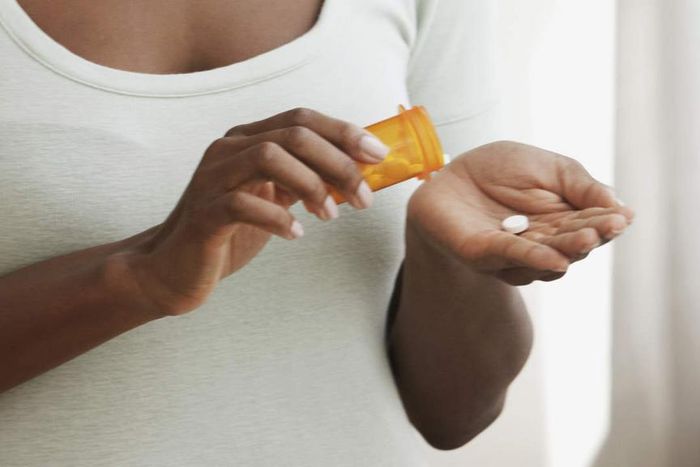 Woman taking meds (Courtesy)