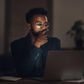 Shot of a young businessman using a laptop during a late night at work