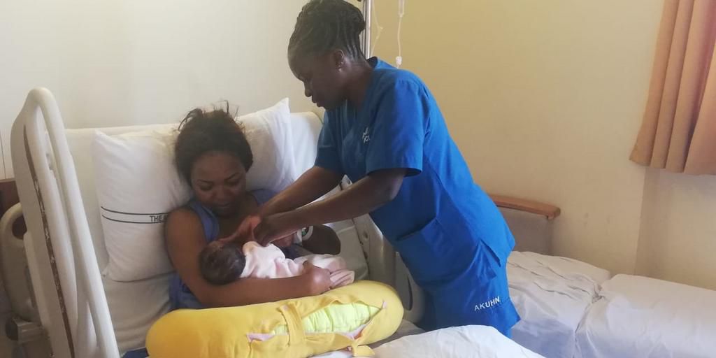 Nurse helps Carolina hold her baby