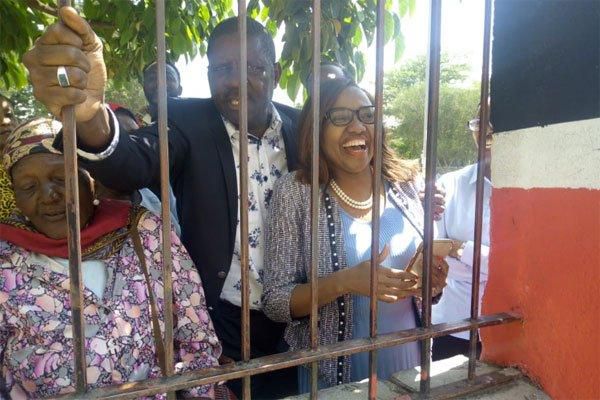 Nakuru Senator Susan Kihika (right) and Nakuru Town East MP David Gikaria blocked from entering the venue where President Uhuru Kenyatta issued more than 2,000 title deeds to members of Nyakinyua women dancers