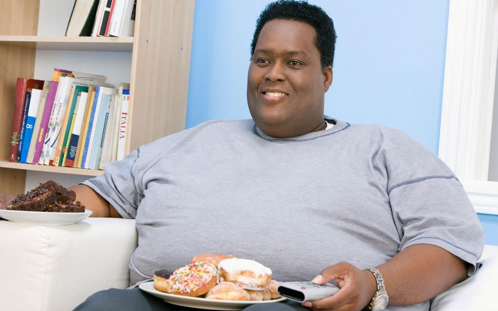 Fat man holding snacks(Ebony Magazine)