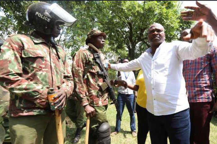 File image of Rashid Echesa surrounded by police at a past event