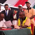 President Uhuru Kenyatta (left), being taken through the Huduma Namba registration form