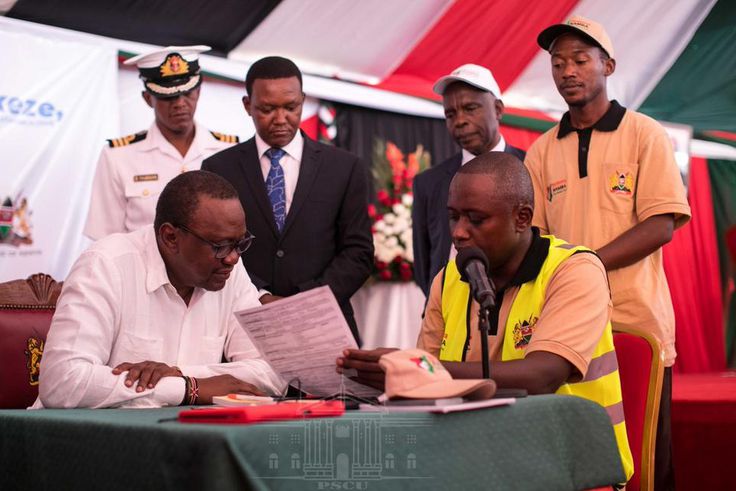 President Uhuru Kenyatta (left), being taken through the Huduma Namba registration form