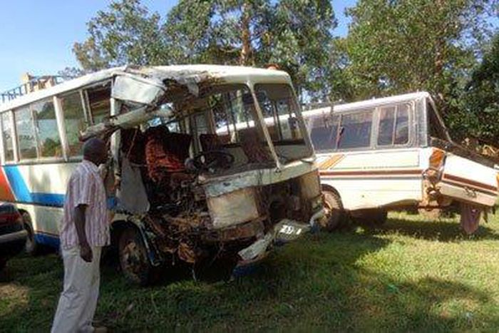 A man stands near the wreckage of the accident vehicles parked at Maga Maga Police Station in Mayuge District on February 25, 2019. PHOTOS BY YAZID YOLISIGIRA