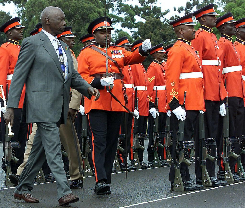 Kenyan President Daniel Arap Moi inspects guards during his farewell parade December 28, 2002.