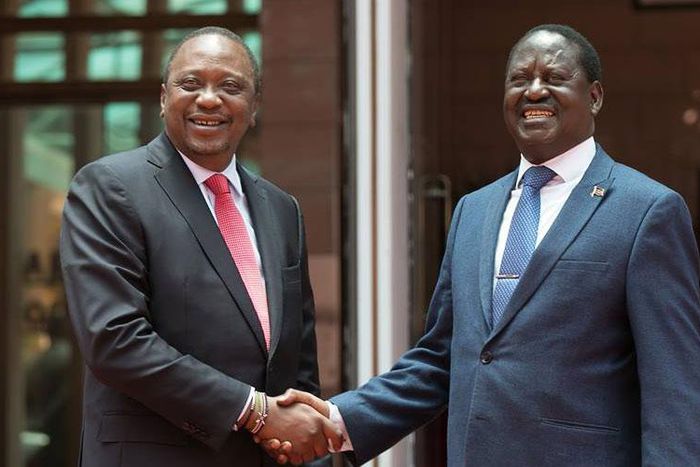 Kenya's President Uhuru Kenyatta (left) and opposition leader Raila Odinga shake hands after meeting at Harambee House, Nairobi on March 9, 2018
