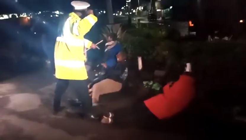 Police whipping Kenyans who were caught up in the night of terror