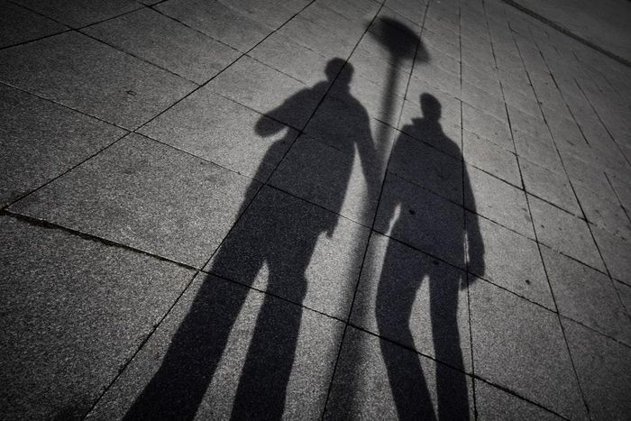 A shadow of two men holding hands (Unspalsh)