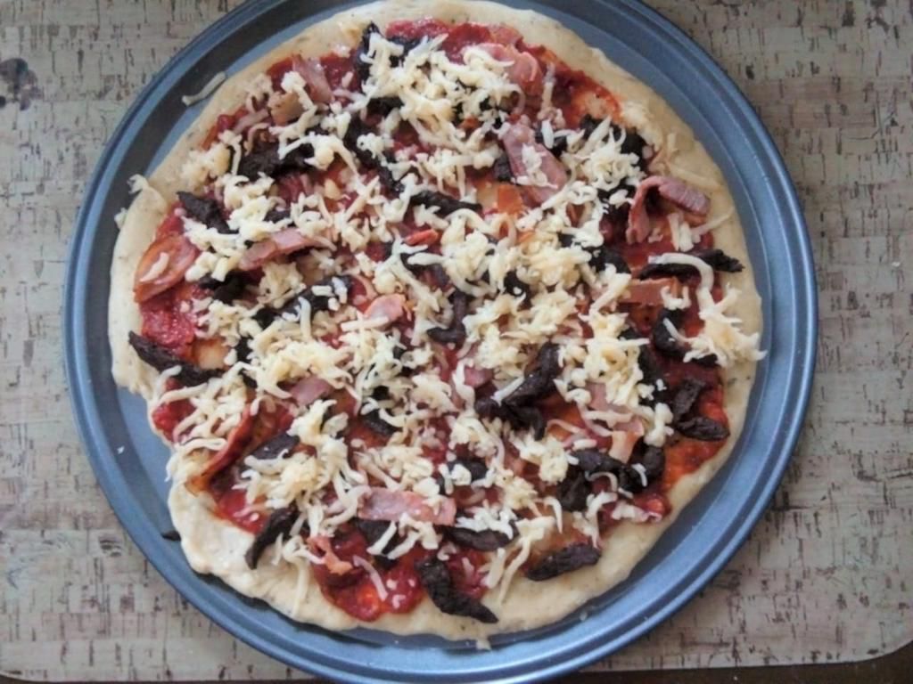 Recipe with a Pulselive twist: Pizza dough with Beef and Bacon toppings with a sprinkle of Mozzarella cheese