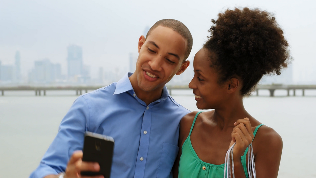 A man and his girlfriend take a selfie [Credit: Videoblocks]