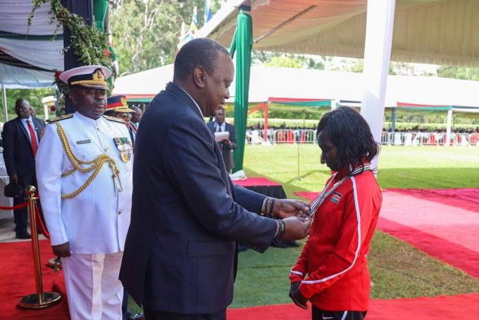 President Uhuru Kenyatta awards decorated athlete Mary Keitany with the OGW title at State House on December 12, 2019