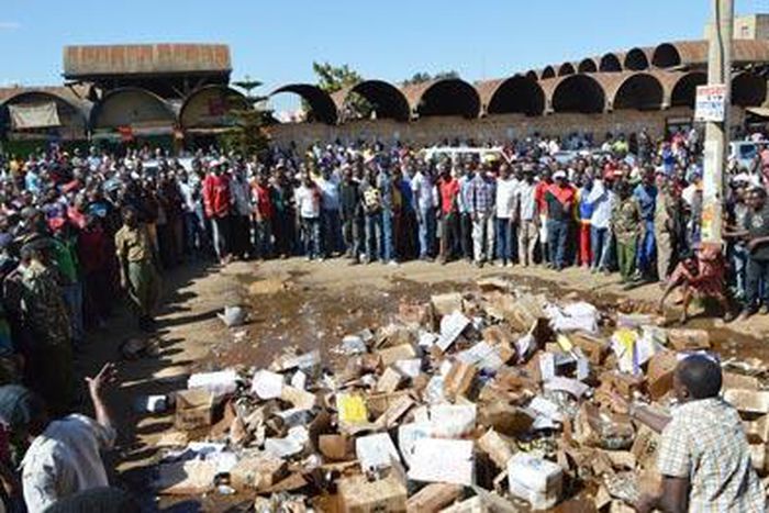 File image of members of the public destroying illegal liquor