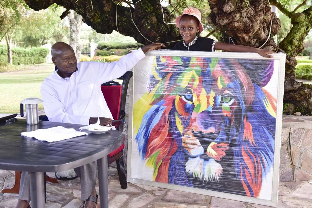 9-year-old Sheila Sheldon Charles presents President Yoweri museveni with another portrait during her visit to Uganda (Twitter)