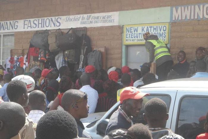 File image of a crowd outside a lodging where a man was caught engaging in sexual acts with a married woman