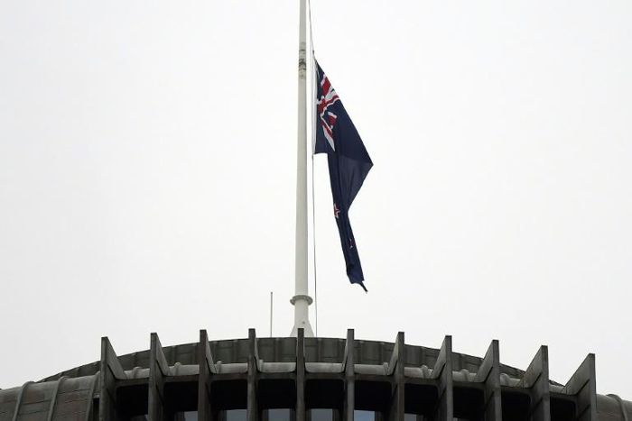 The New Zealand flag hangs at half mast outside the parliament building in Wellington on Tuesday following last week's mosque massacre