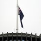 The New Zealand flag hangs at half mast outside the parliament building in Wellington on Tuesday following last week's mosque massacre