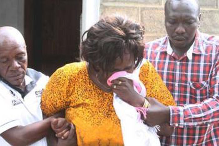 Family members overcome by grief during the burial of Collins Kipyegon Kalya