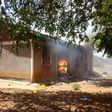 One of the houses on fire after angry residents stormed a police station after suspect’s controversial death in cell